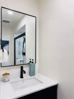 a bathroom with a sink and a large mirror at Modern King Room Private Ensuite Vancouver West in Vancouver