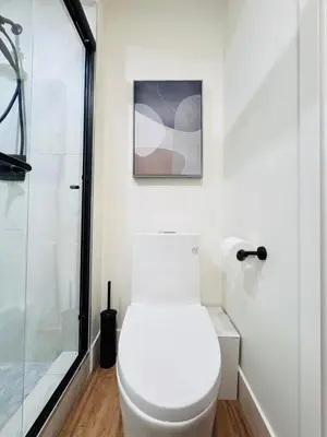 a bathroom with a toilet and a shower at Modern King Room Private Ensuite Vancouver West in Vancouver