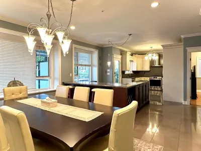 a dining room and kitchen with a table and chairs at Spacious 5BR 3BA Guest Villa - 10 Min to DT - Pet Friendly, Free Parking in Vancouver