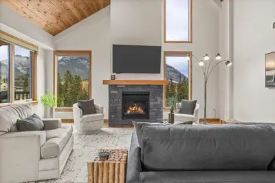 a living room with a couch and a fireplace at Spring Creek Luxury - managed by Little Sister Getaways in Canmore