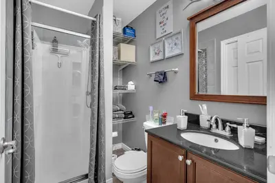 a bathroom with a toilet and a sink and a shower at 33 Executive Home, Ac, Airport in Calgary