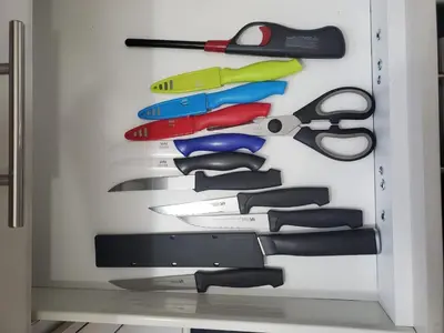 a drawer filled with lots of different types of scissors at 33 Executive Home, Ac, Airport in Calgary