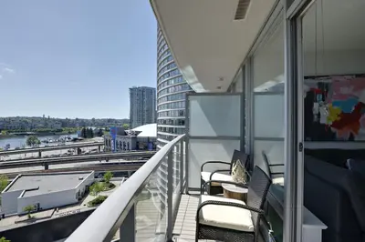 a balcony with chairs and a view of a city at Luxary Condo Downtown Vancouver with free parking in Vancouver