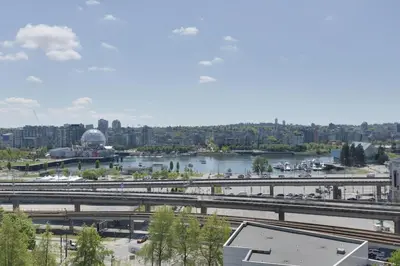 a view of a city with a river and a bridge at Luxary Condo Downtown Vancouver with free parking in Vancouver