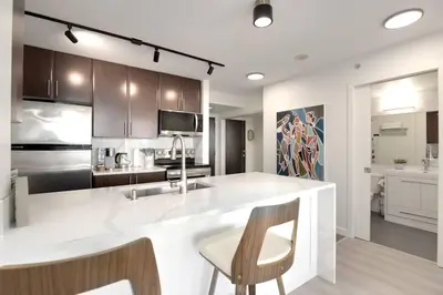 a kitchen with a large white island in a kitchen at Luxary Condo Downtown Vancouver with free parking in Vancouver