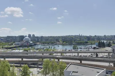 a view of a city with a river and a bridge at Luxary Condo Downtown Vancouver with free parking in Vancouver