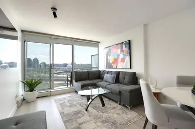 a living room with a couch and a table at Luxary Condo Downtown Vancouver with free parking in Vancouver