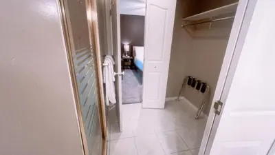 a small bathroom with a door leading to a hallway at Cornerstone Bed and Breakfast in Revelstoke