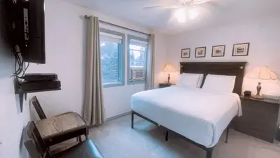 a bedroom with a white bed and a window at Cornerstone Bed and Breakfast in Revelstoke