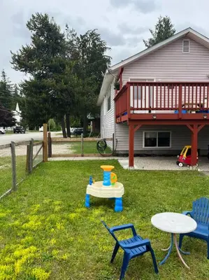 a backyard with a table and two chairs and a table at Michaud's Basement unit in Nakusp