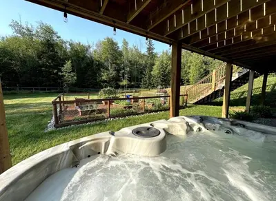 a hot tub in the middle of a field at Caribou Lodge in Terrace
