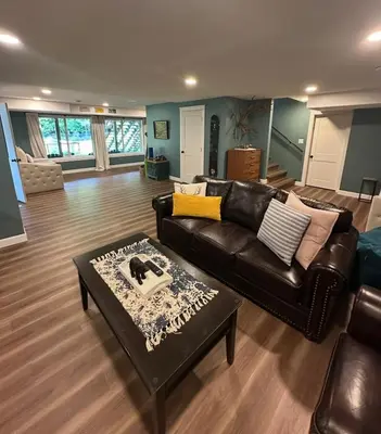 a living room with a leather couch and a coffee table at Caribou Lodge in Terrace