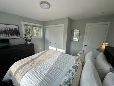 a bedroom with a large bed and a window at Caribou Lodge in Terrace