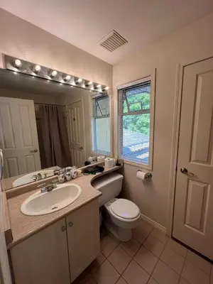 a bathroom with a sink and a toilet and a mirror at Terra Nova - Private property in Richmond