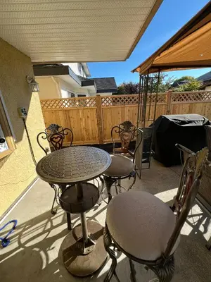 a patio with a table and chairs and a fence at Terra Nova - Private property in Richmond