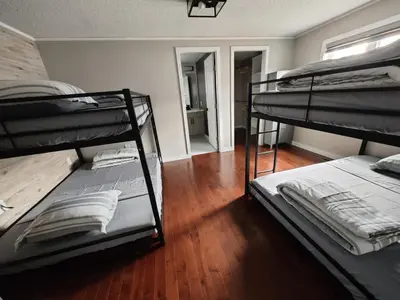 a room with two bunk beds and a hallway at EC Lodging in Yellowknife