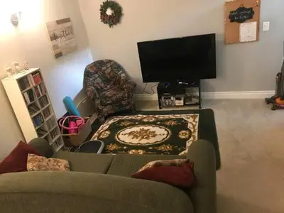 a living room with a couch and a tv at The Musical Perch in Kelowna