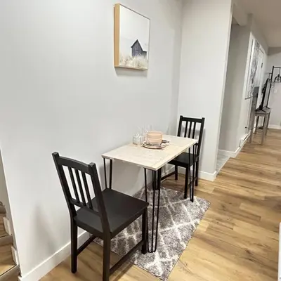 a dining room table and chairs in a room at Comfortable and centrally located guest suite in Calgary