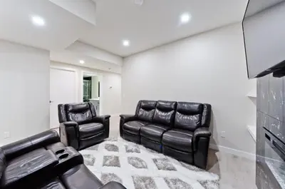 two black leather chairs in a living room at Executive Bliss Suites in Calgary