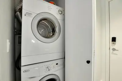 a white washer and dryer in a room at Luxury Condo in Downtown Vancouver with city view in Vancouver