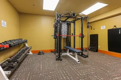 a room with a gym with weights at Slalom Creek 3 Bedrooms in Rossland