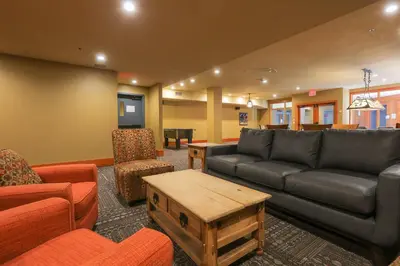a living room with a couch and a table at Slalom Creek 2 Bedrooms in Rossland