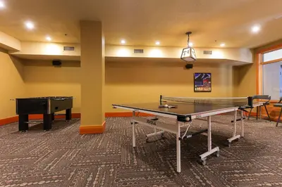 a room with two ping pong tables and a ping pong table at Slalom Creek 2 Bedrooms in Rossland