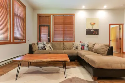 a living room with a couch and a coffee table at Slalom Creek 3 Bedroom in Rossland