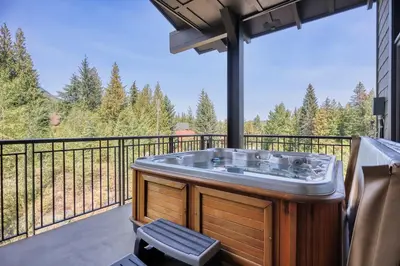 a hot tub on the balcony of a house at Slalom Creek 3 Bedroom in Rossland