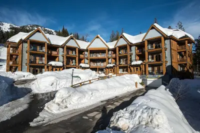 a large apartment building with snow on the ground at Silver Tip 2 Bedroom Condo in Rossland