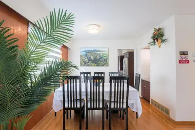 a dining room with a table and a plant at Vancouver Getaway in Vancouver