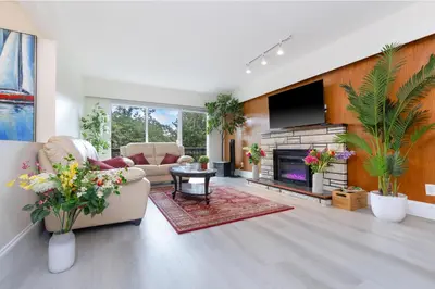 a living room with a couch and a fireplace at Vancouver Getaway in Vancouver