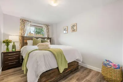 a bedroom with a large bed and a window at 2BR Cozy Suite w Fireplace! FREE Banff Pass, Parking, Netflix! Near Golf Course! in Calgary