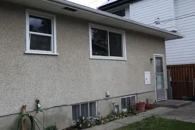 a house with two windows and a door at Calgary's Home Cinema Retreat in Calgary
