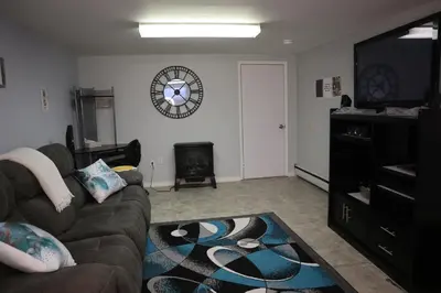 a living room with a couch and a flat screen tv at Calgary's Home Cinema Retreat in Calgary