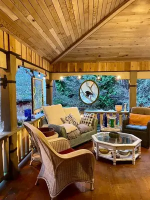 a living room with a couch and chairs and a table at Hummingbird Gardens B&B in Ladysmith