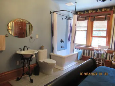 a bathroom with a toilet and a shower and a sink at Hummingbird Gardens B&B in Ladysmith