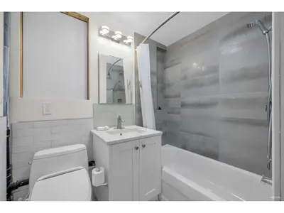 a bathroom with a toilet and a sink and a tub at Cozy 3BR Holiday Retreat 2 Free Parking AC King BD in Vancouver