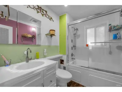 a bathroom with a sink and a toilet and a shower at Cozy 3BR Holiday Retreat 2 Free Parking AC King BD in Vancouver