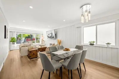 a dining room and living room with a table and chairs at Cozy 3BR Holiday Retreat 2 Free Parking AC King BD in Vancouver