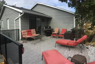 a patio with chairs and a table and a desk at Trader Vics Tiki Bar n Grill in Nanaimo