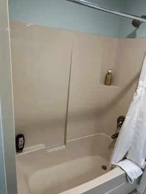 a bathroom with a bath tub with a towel at Aloha Cottage, Nanoose Bay - 2 Bdrm Oceanfront Unit with Private Deck in Nanoose Bay
