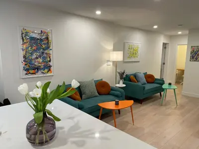 a living room with two blue couches and a table at Almost Home in West Vancouver