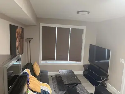 a living room with a couch and a flat screen tv at Home away from home in Prince George