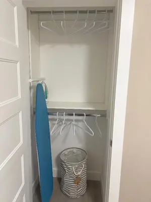a door of a closet with a surfboard in it at Home away from home in Prince George