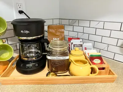 a wooden tray with a coffee maker and ingredients on a counter at Swallow's Perch Guest Suite in Vesuvius