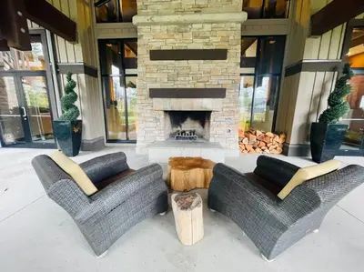a living room with two chairs and a fireplace at ENTIRE Sunrise Resort Townhome in Parksville in Parksville