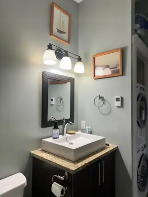 a bathroom with a white sink and a mirror at Eagle Way in Port Renfrew