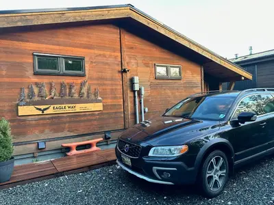 a car parked in front of a tiny house at Eagle Way in Port Renfrew
