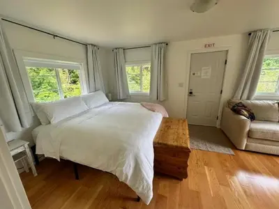 a bedroom with a large white bed and a couch at Silva Bay View BnB in Gabriola